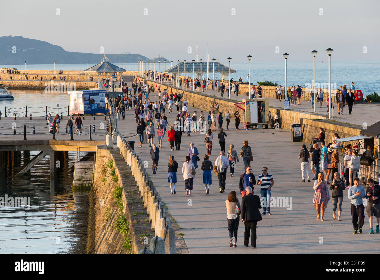 large crowd people walking dun laoghaire pier walk Stock Photo