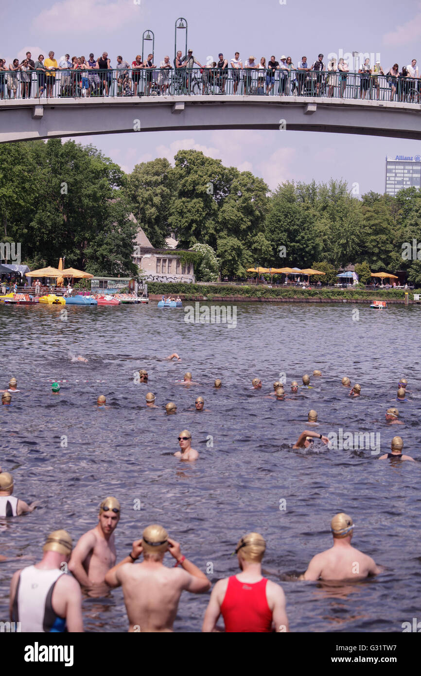 10 th edition of the Berlin Triathlon, which start with the disciplin of  swimming around the  Isle of Youth in Tretowerpark. After, the competitors takes the bicycles and start the 38 kilometer bike course which runs along the Plänterwald . Then they run 10,25 km. Other categories have shorter distances. Stock Photo