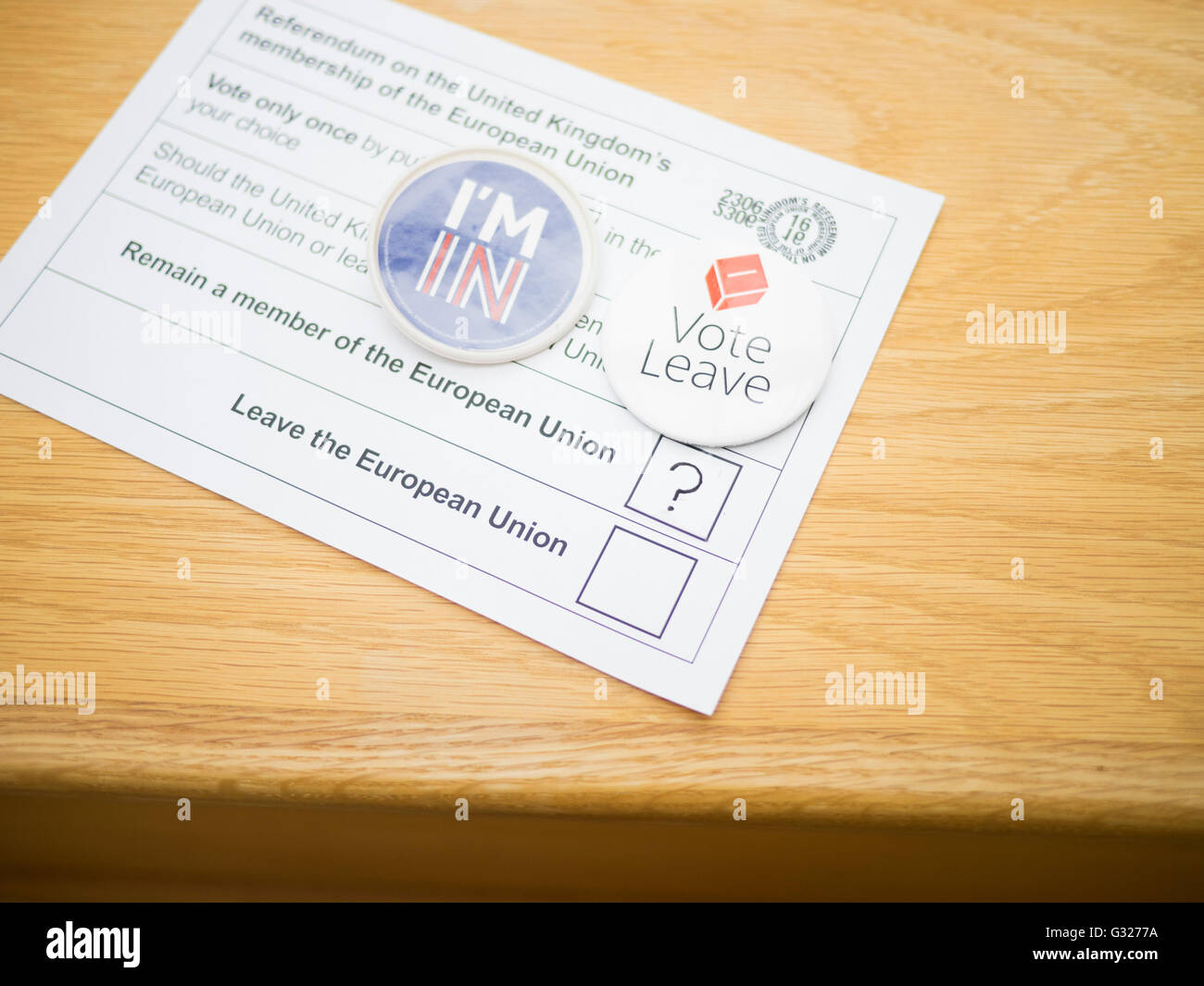 Exeter UK 7 June 2016 EU referendum voting by postal ballot floating voter undecided question mark unanswered question. opposing badges, I'm in and vote leave Stock Photo