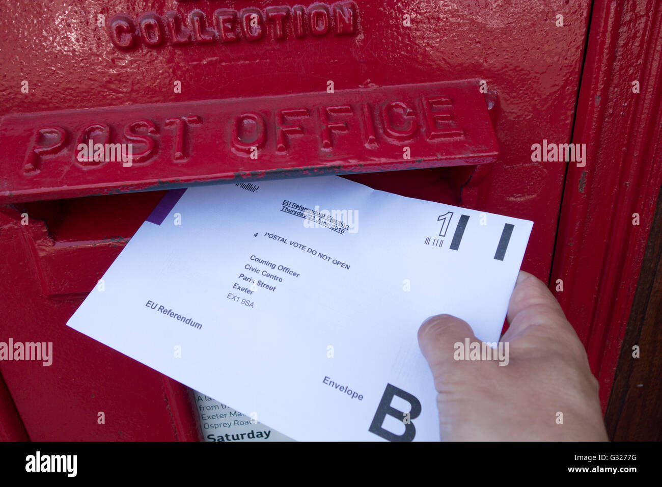 Exeter UK 7 June 2016 EU referendum voting by postal ballot posting vote into a post box. Last day to apply for a postal vote tomorrow. Stock Photo