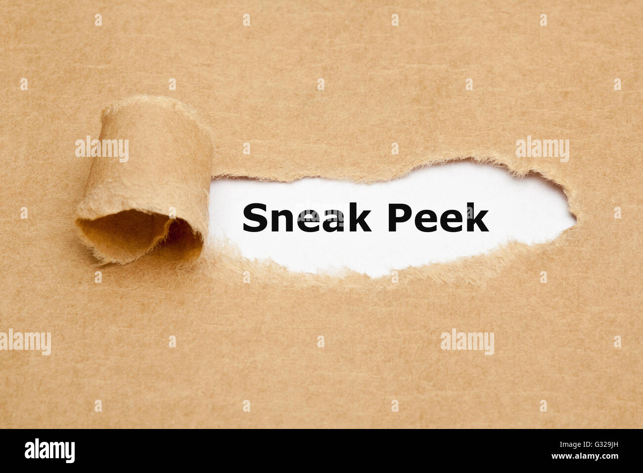 The phrase Sneak Peek appearing behind torn brown paper. Stock Photo