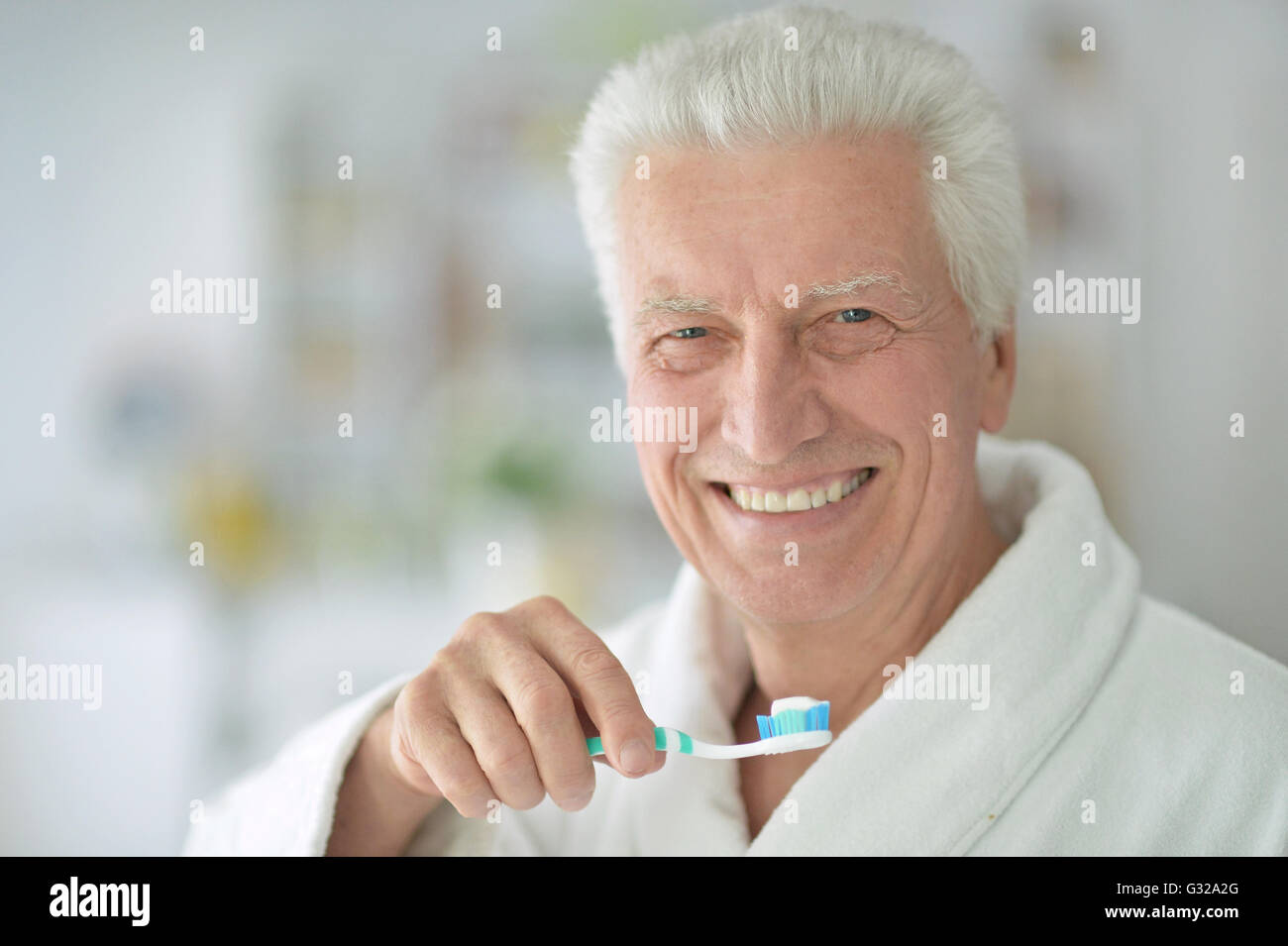 elderly man  brushing his teeth Stock Photo