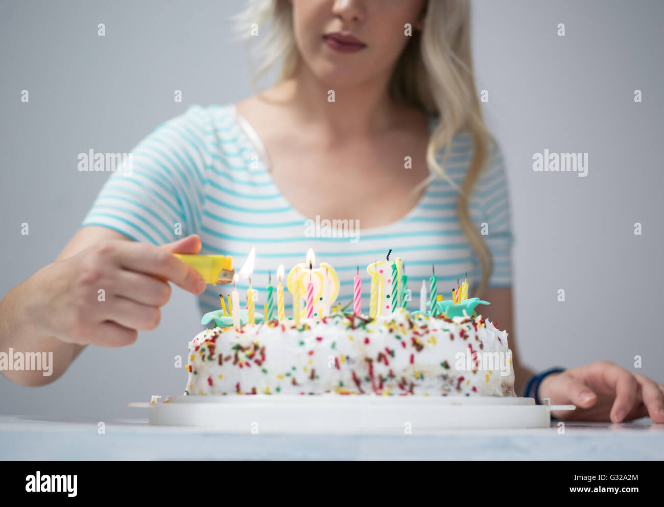 Portrait of a young beautiful blond girl holding plate with birthday ...