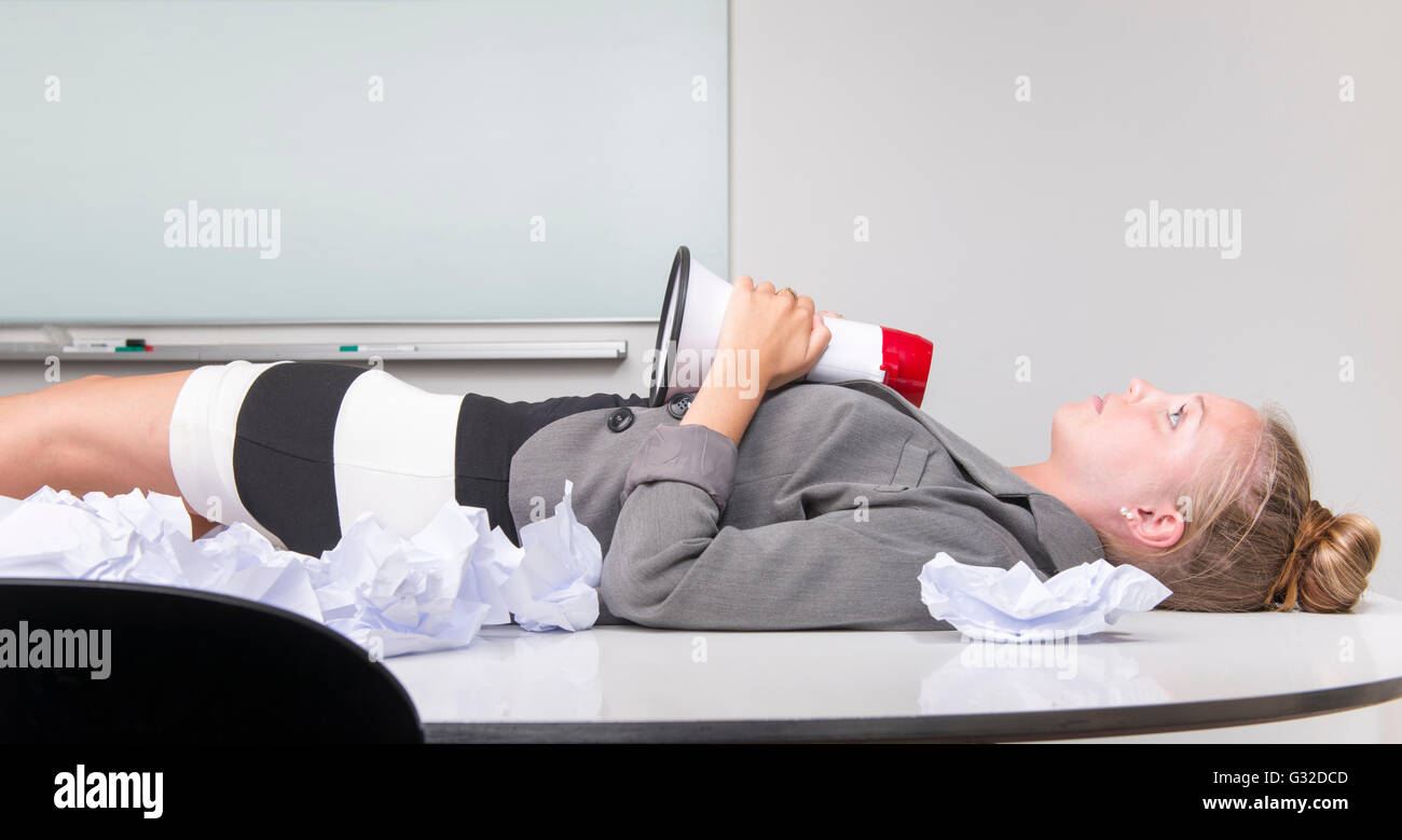 Businesswoman Having A Break Lying On Her Desk Exhausted From