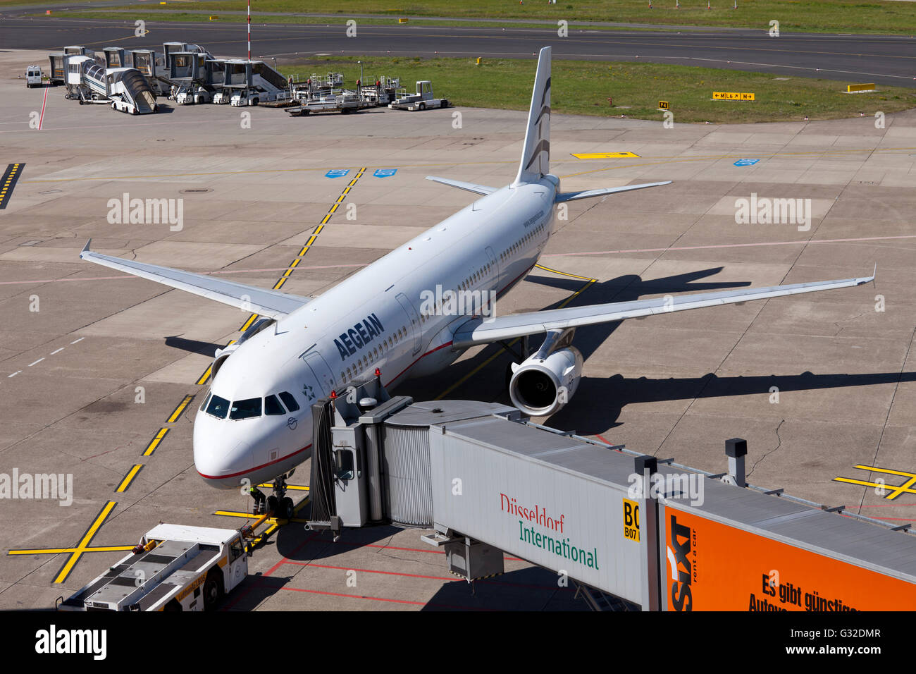AegeanAir SX-DGA Airbus A 321-232 aircraft being attached to a jetway or passenger boarding bridge on the airport apron, Stock Photo