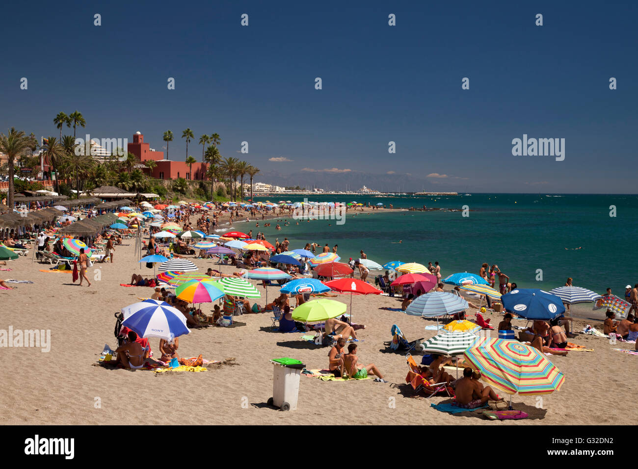 The busy Playa de Santa Ana beach and Castillo El Bil-Bil castle, Benalmadena, Malaga province, Costa del Sol, Andalusia, Spain Stock Photo