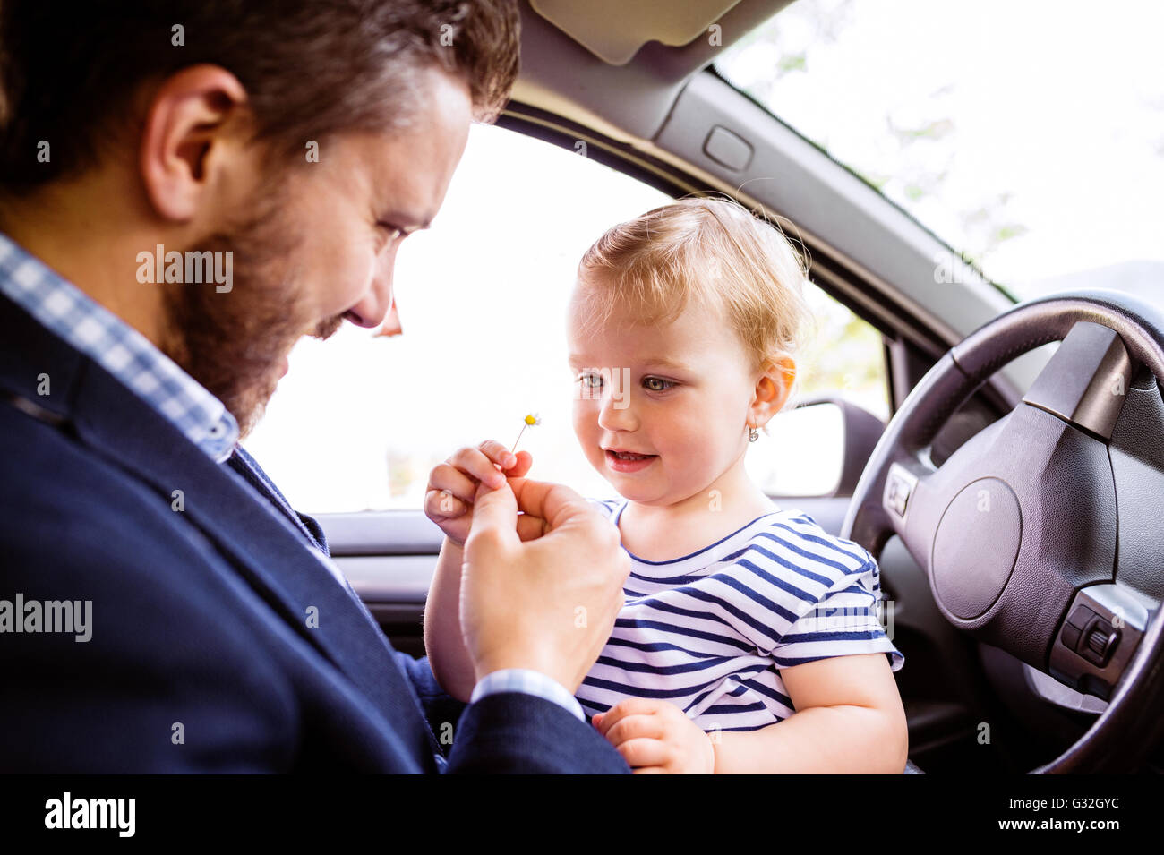 Hipster father with his little daughter in the car Stock Photo