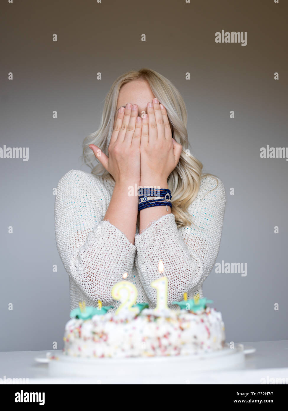 Portrait of a young beautiful blond girl holding plate with birthday ...