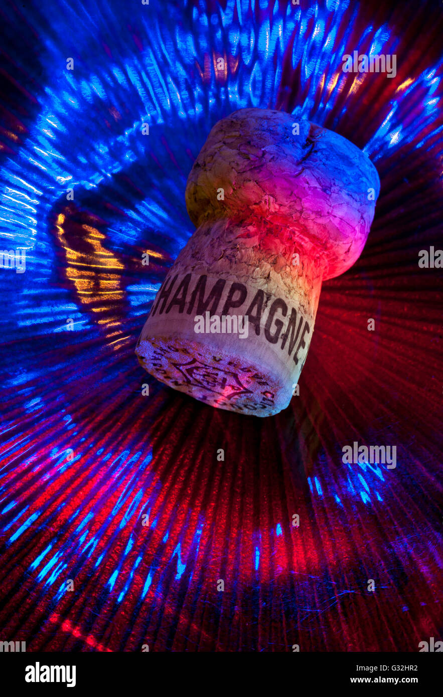 Champagne cork on party disco dancing table surface with interior  multicolour special event celebration lighting. French Sparkling Wine Stock Photo