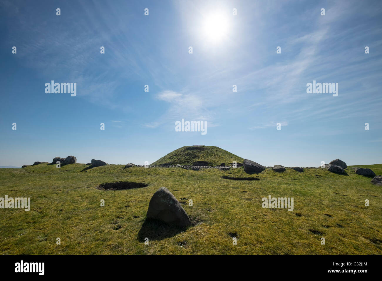 Sun shines in blue sky over the ancient ritual site of Cairnpapple Hill in West Lothian Scotland Stock Photo