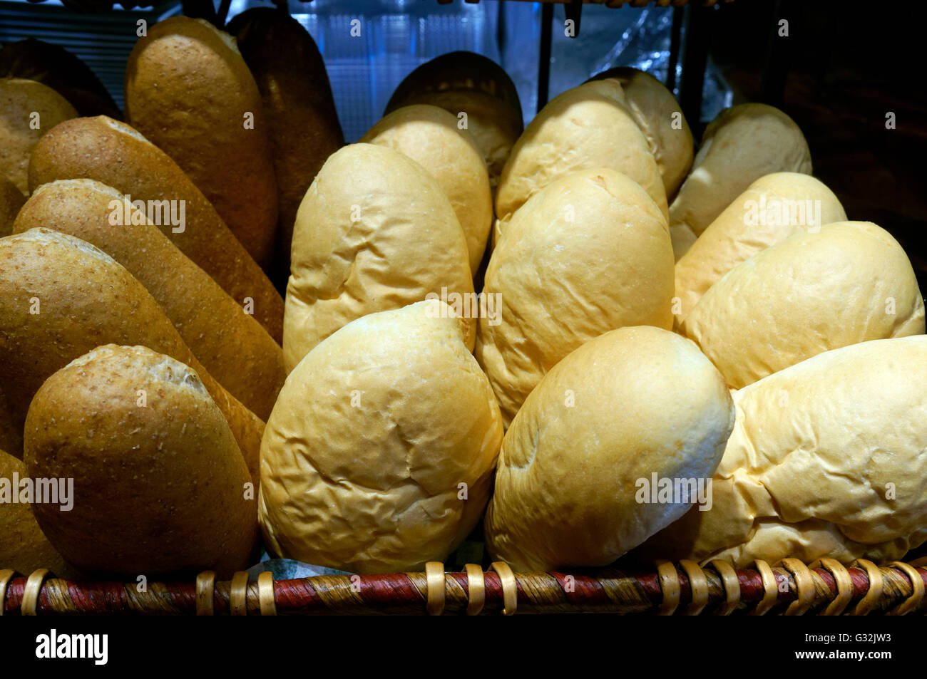A basket of brown and white panini bread rolls Stock Photo