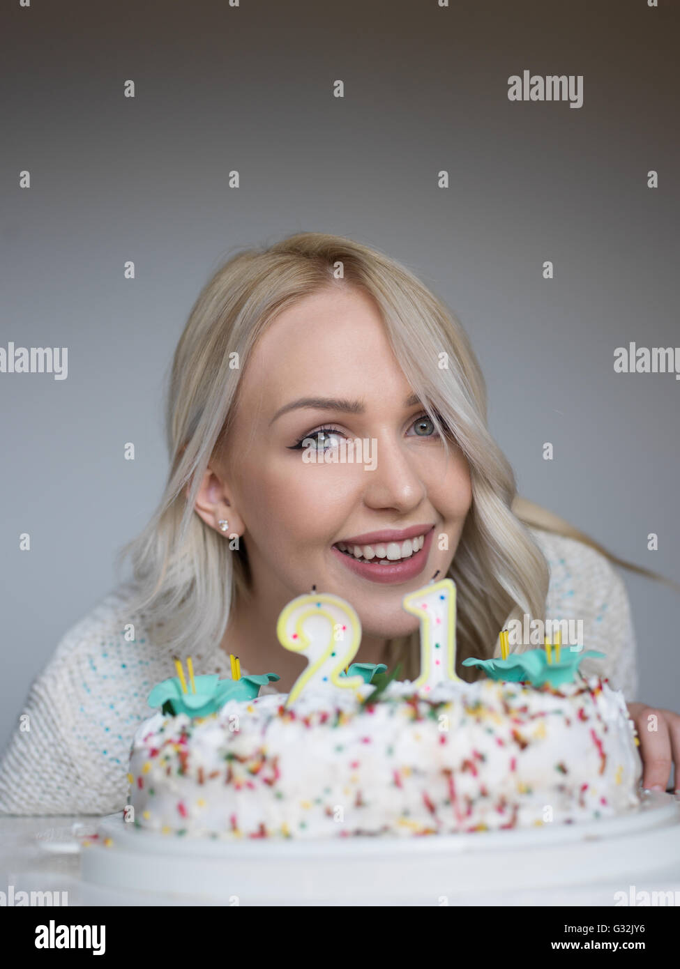 Portrait of a young beautiful blond girl holding plate with birthday ...