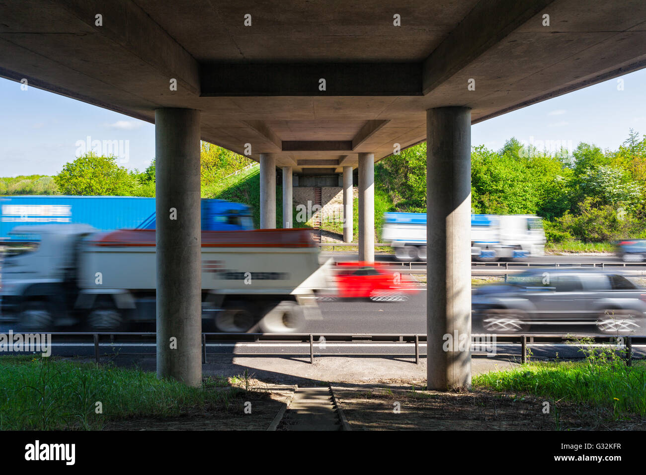 Cars in Motion On Busy Motorway under the Bridge Stock Photo