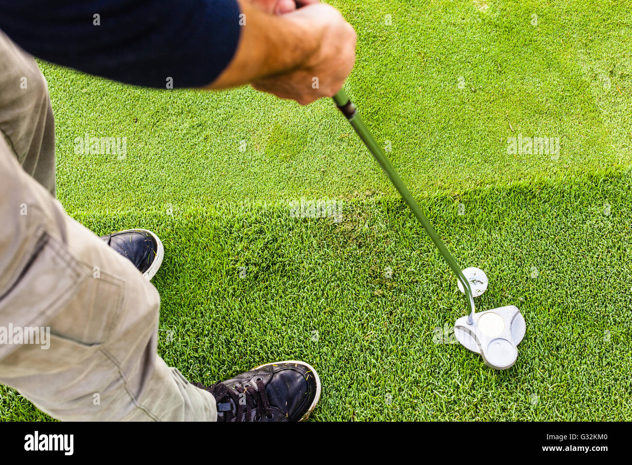 Putter Aim a golf player aiming for the hole on the green with a putter Stock ...