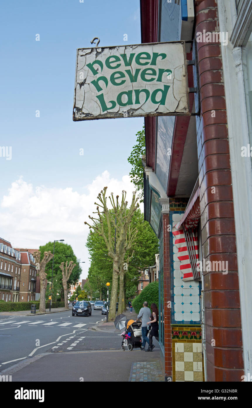 Distressed and faded shop sign for Never Never Land on Fortis Green, London. Stock Photo
