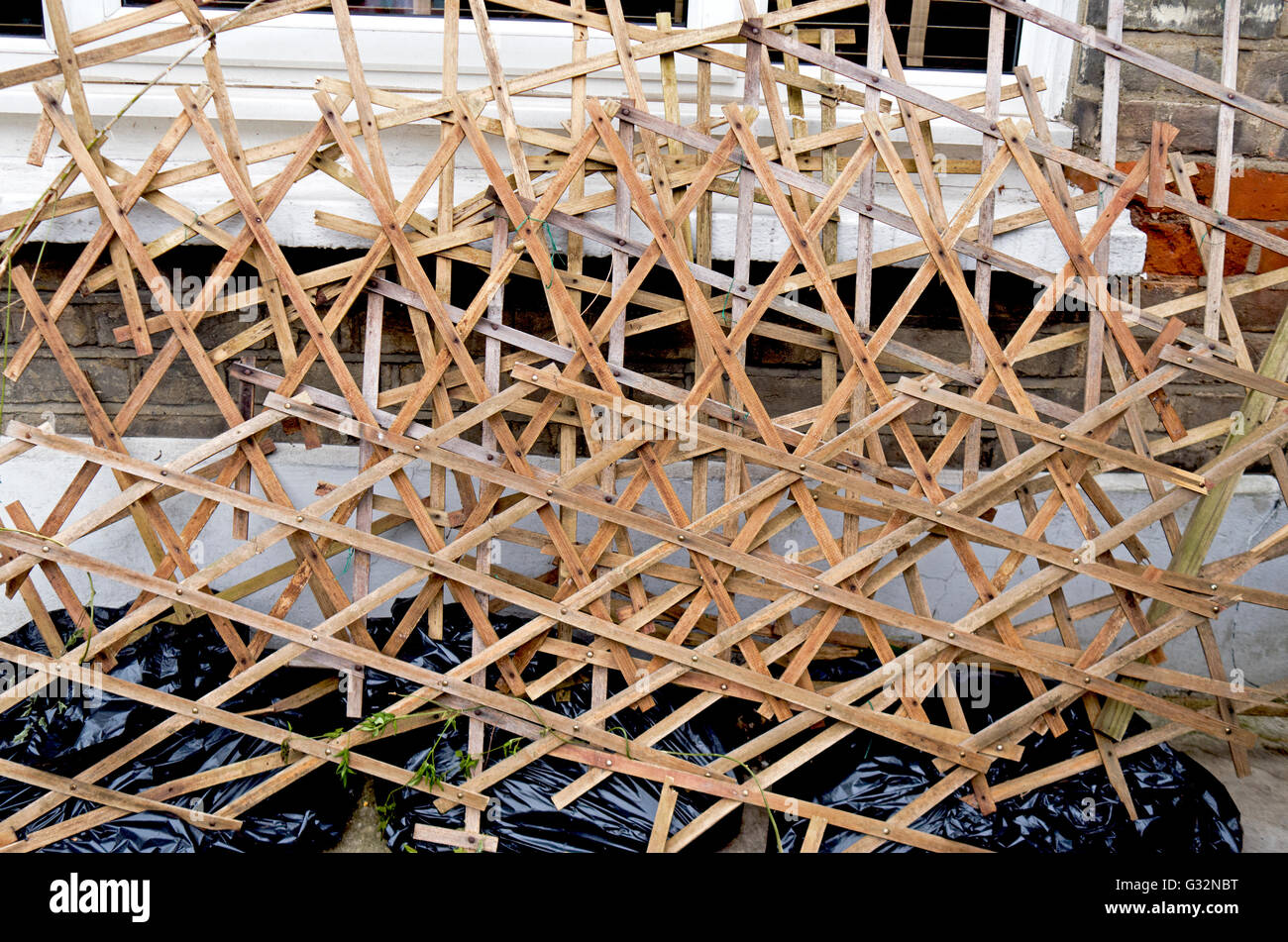 Criss-crossing wooden trellis Stock Photo