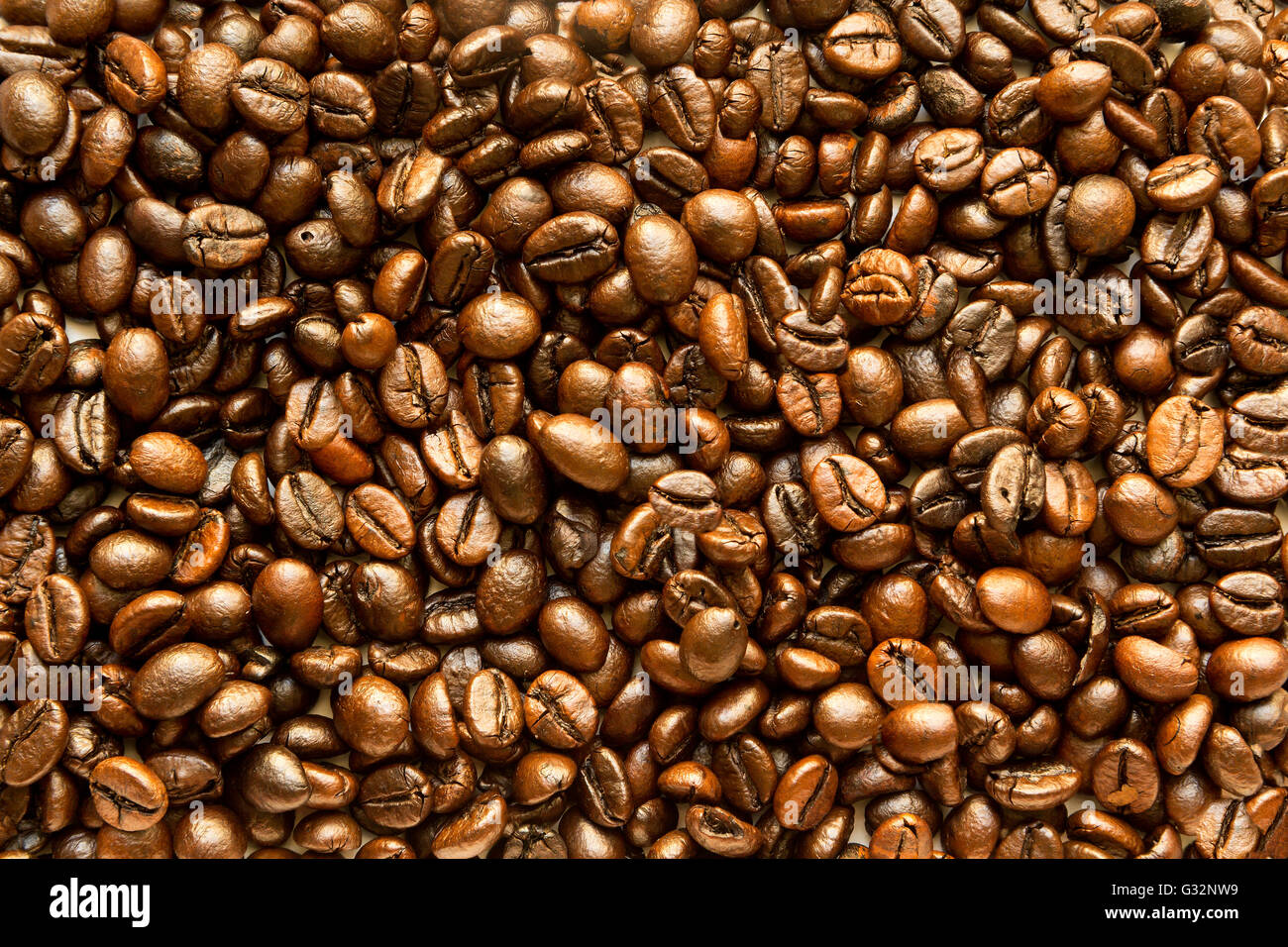 the texture of the coffee beans roasted Brown background Stock Photo ...