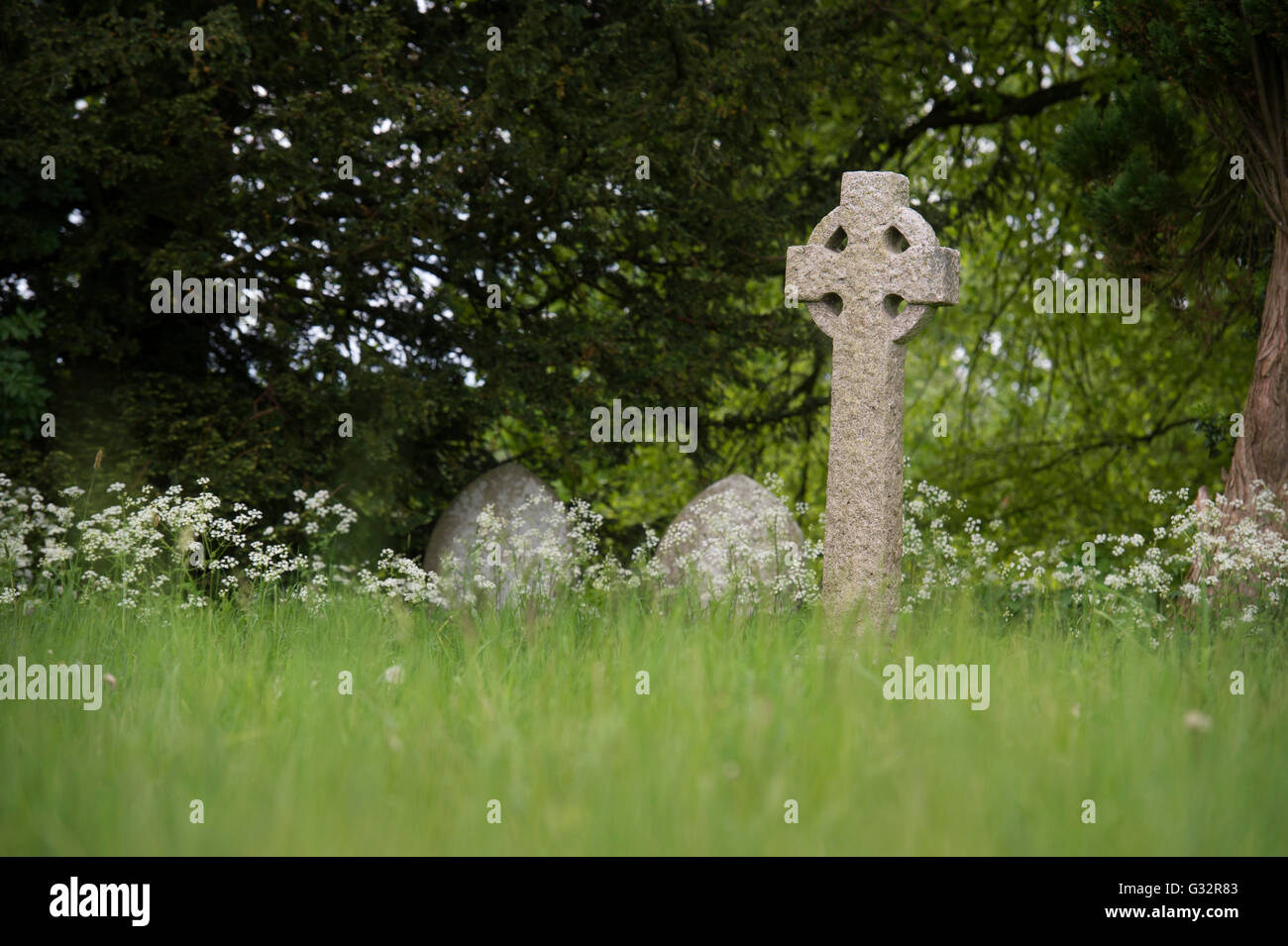 Cross headstone in Sherborne cemetery, Cotswolds, Sherborne, Gloucestershire, UK Stock Photo