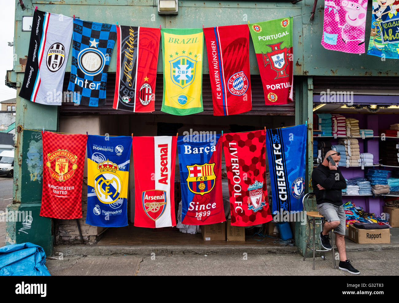 Stall selling football team towels at Barras Market in Gallowgate, Glasgow, united Kingdom Stock Photo