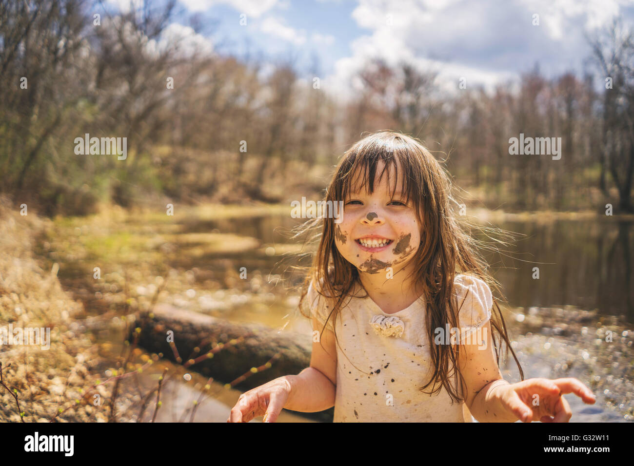 Portrait of a Girl with mud on her face laughing, USA Stock Photo