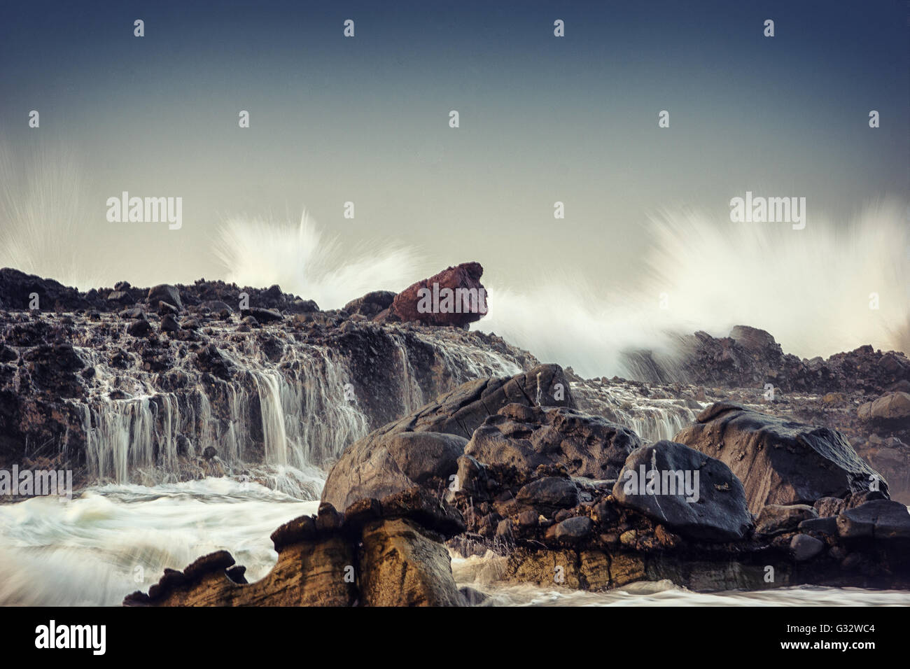 Waves crashing on rocks on beach, Karang Beureum, Sawarna, Indonesia Stock Photo