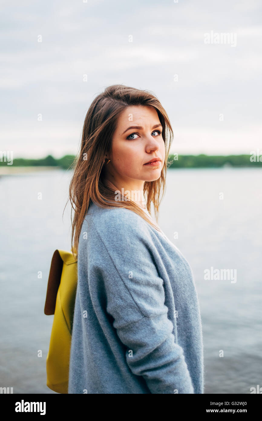 Portrait of woman standing by sea Stock Photo - Alamy