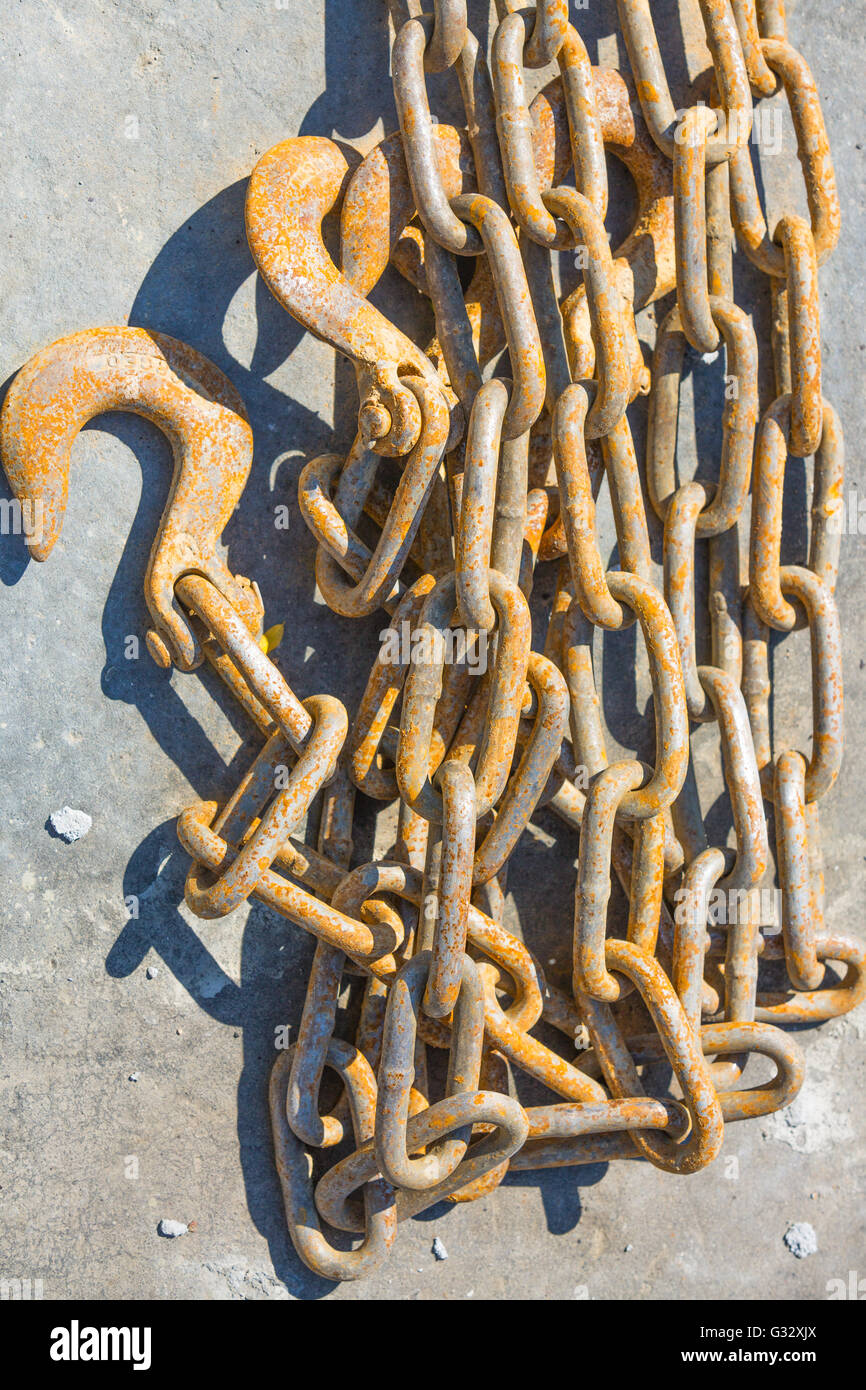 a length of lightly rusted metal chain with two hooks Stock Photo