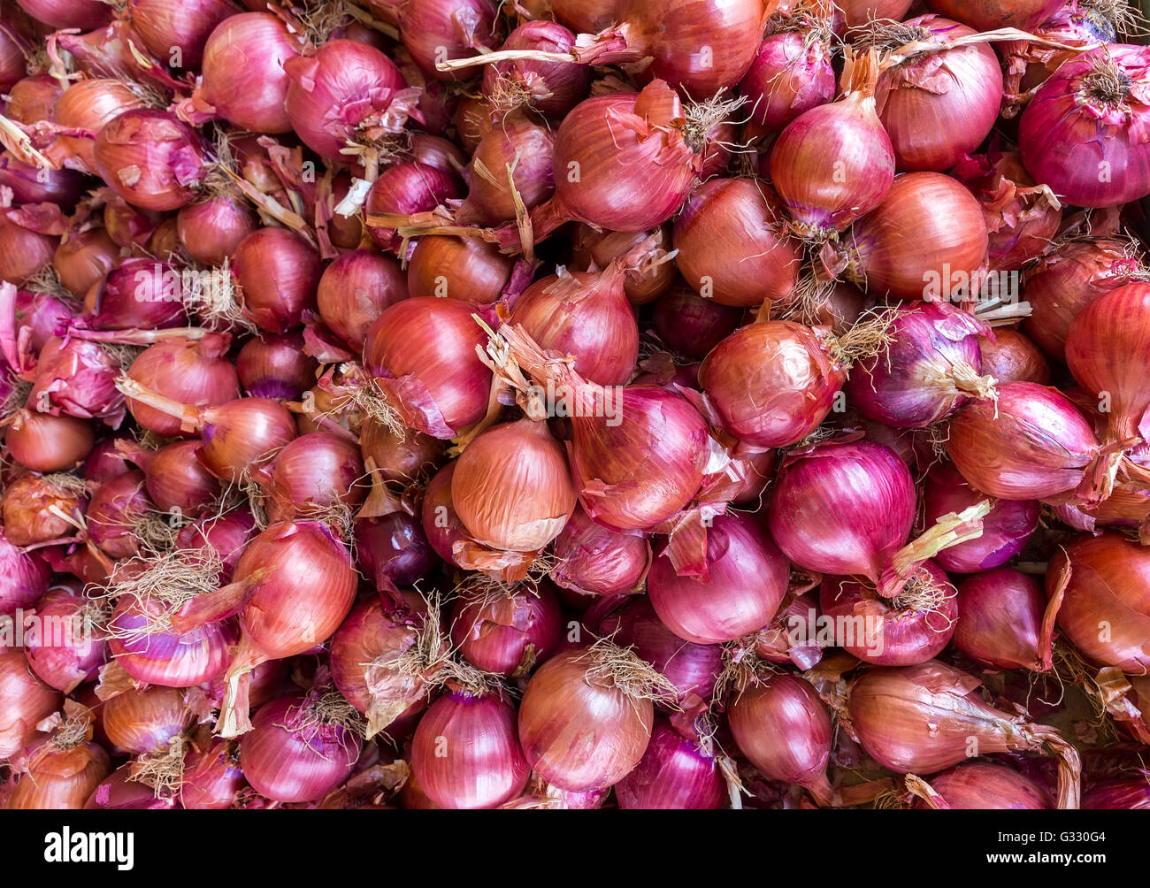 Heap of red onions on market place Stock Photo