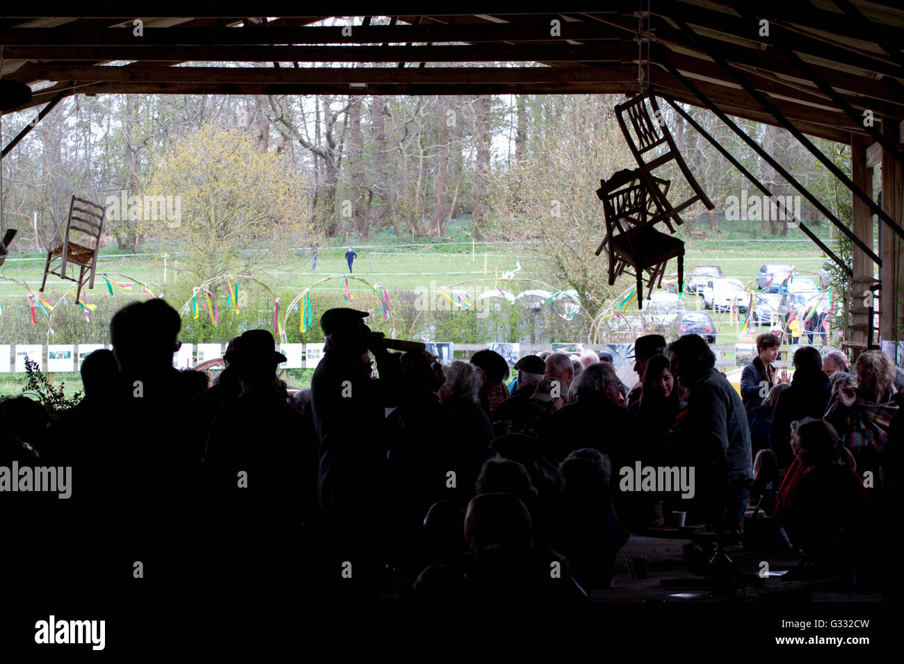 Silhouette of crowd at an arts festival with chairs hanging in the air Stock Photo