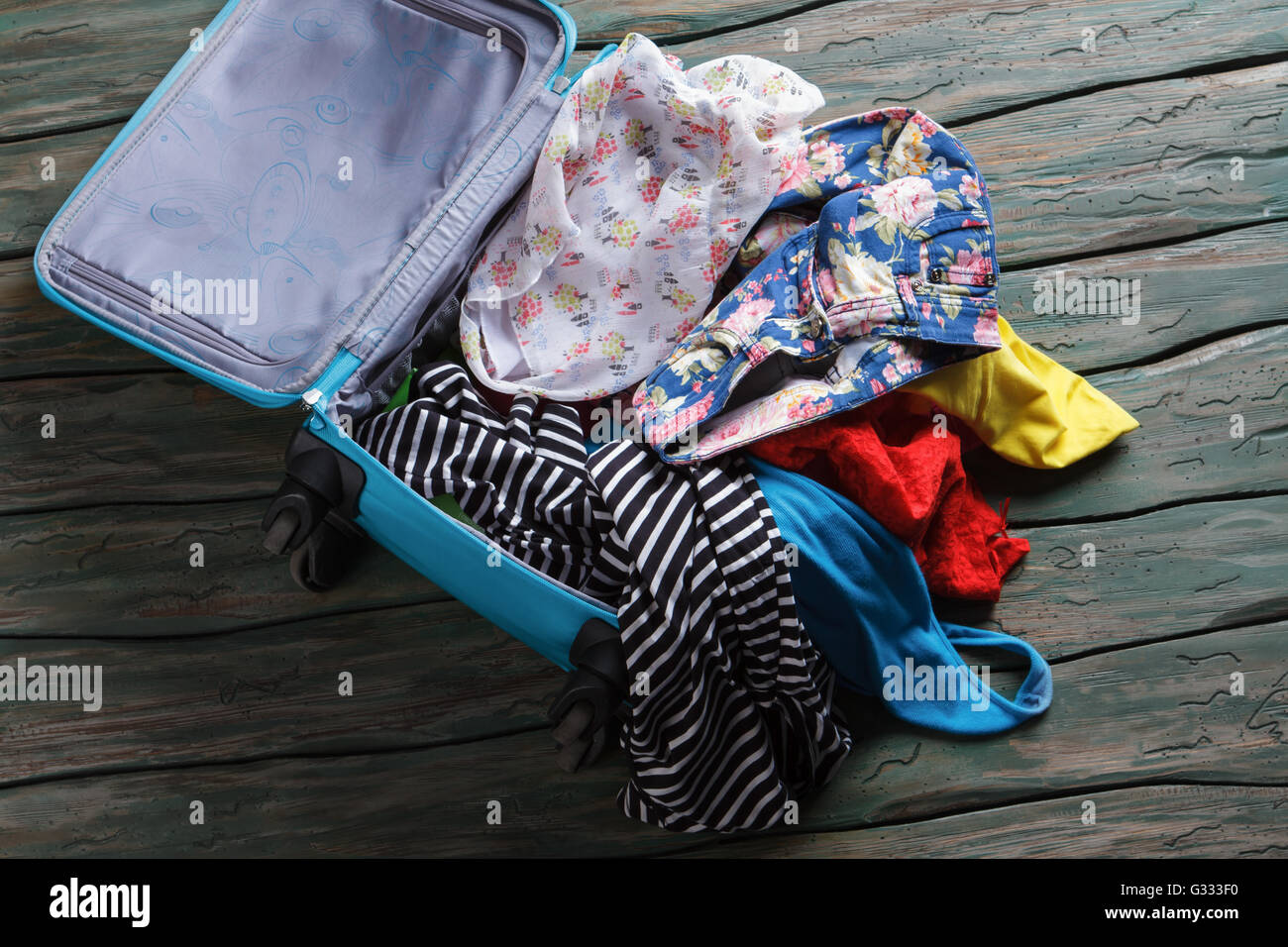 Opened suitcase with clothes. Stock Photo