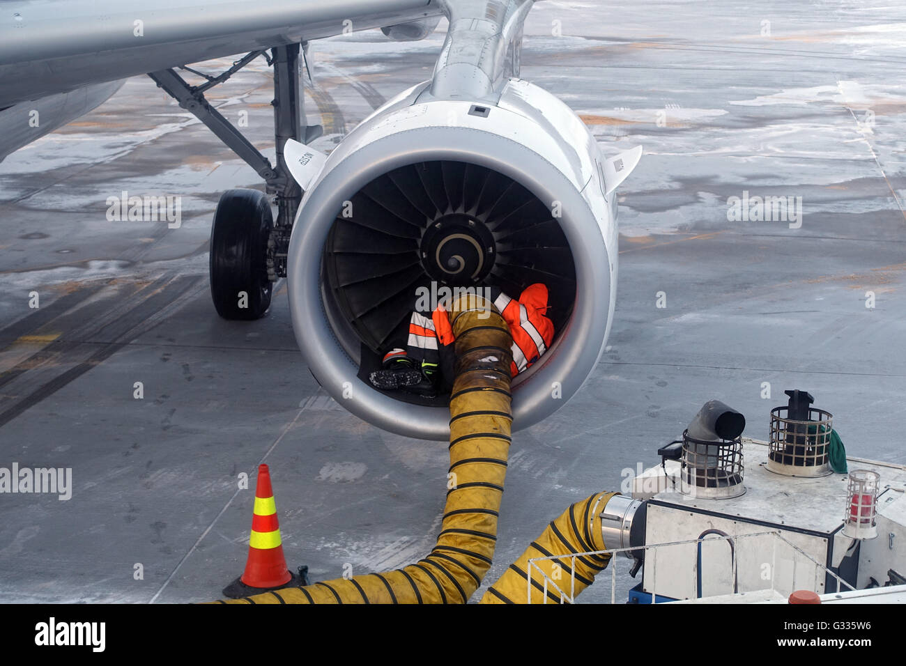 Kittilae, Finland, ramp agent warms in the winter the engine of an