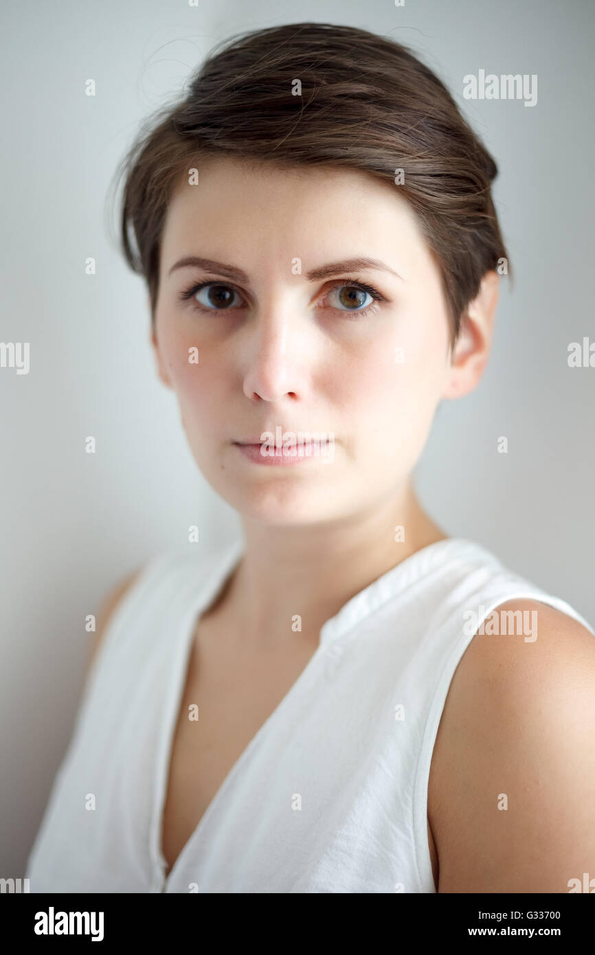 Charming short hair young woman without makeup on white background Stock Photo