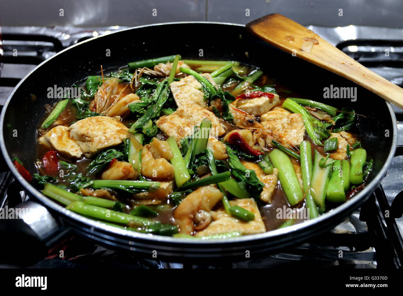 Stir fry tofu with prawns and choy sum - home cooked Asian food Stock Photo