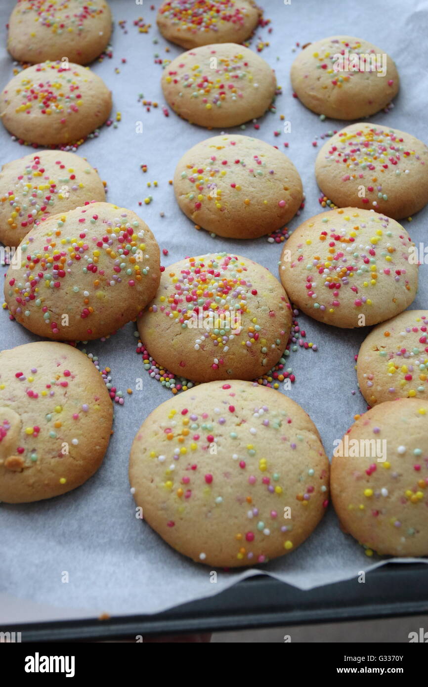 Freshly Baked cookies with hundreds and thousands on top Stock Photo