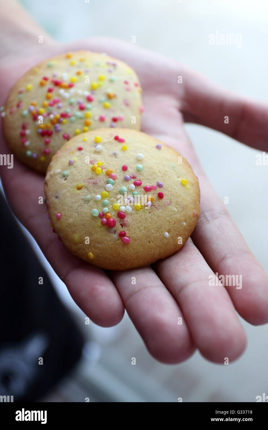 Freshly Baked cookies with hundreds and thousands on top Stock Photo