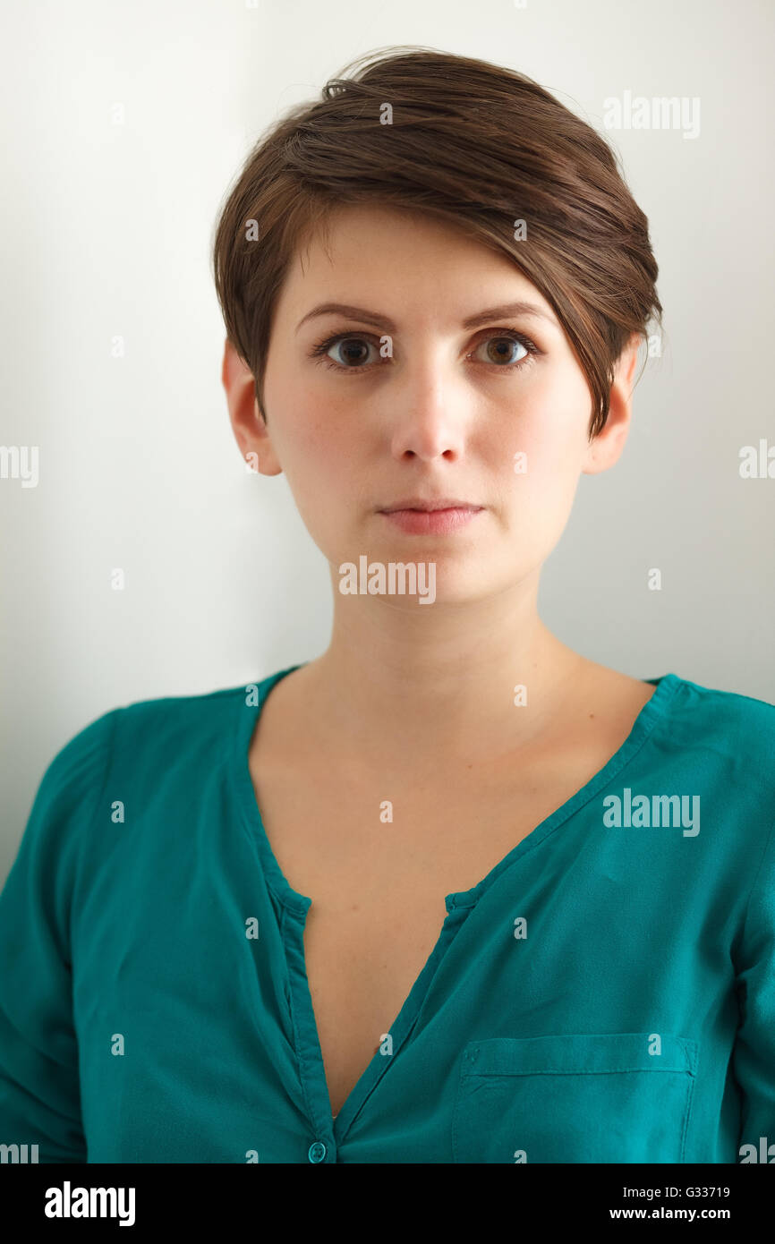 Charming short hair woman without makeup on white background Stock Photo