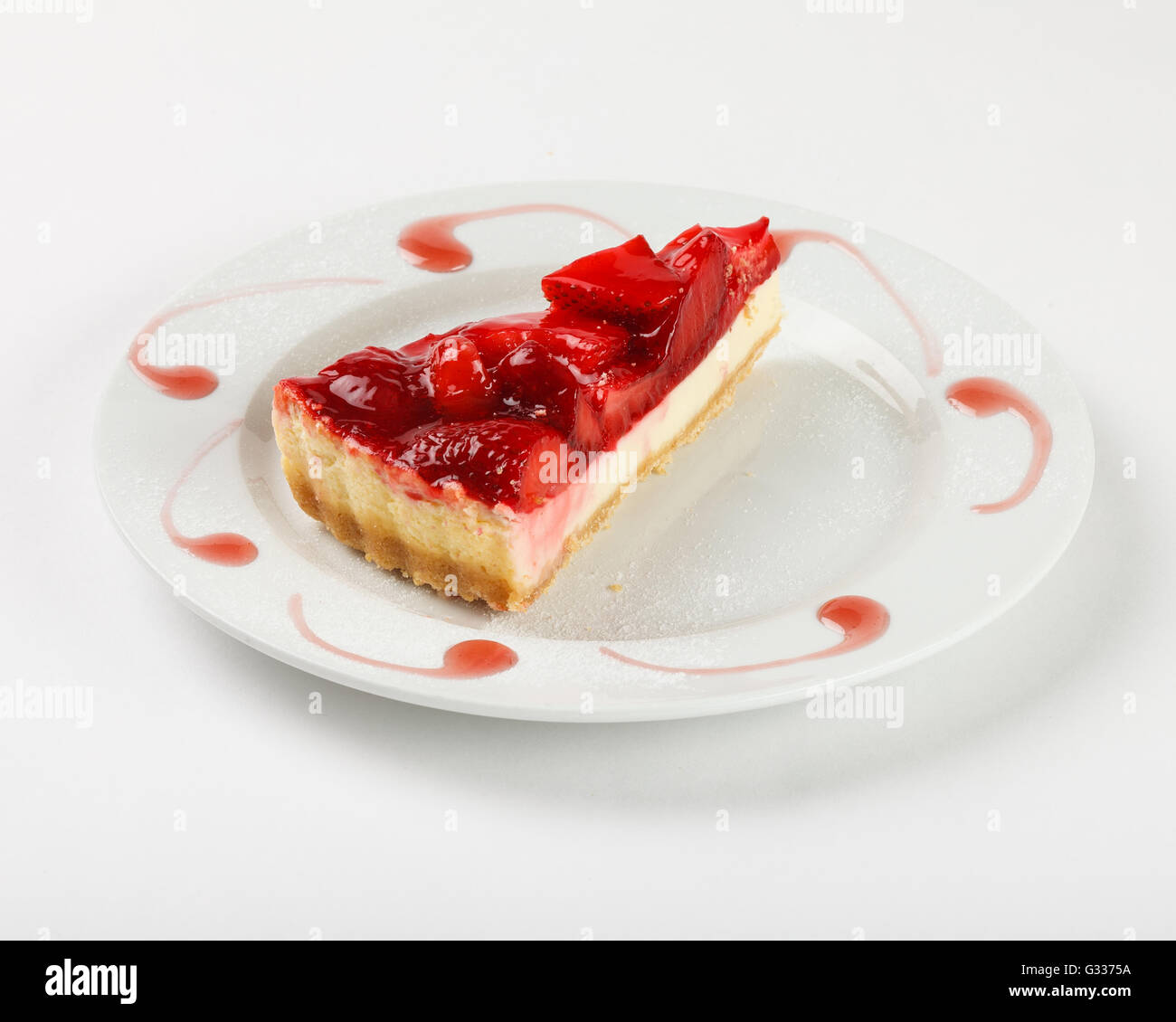 Delicious cheesecake with strawberry jelly and jam on the plate on white background. Close up side view. Stock Photo