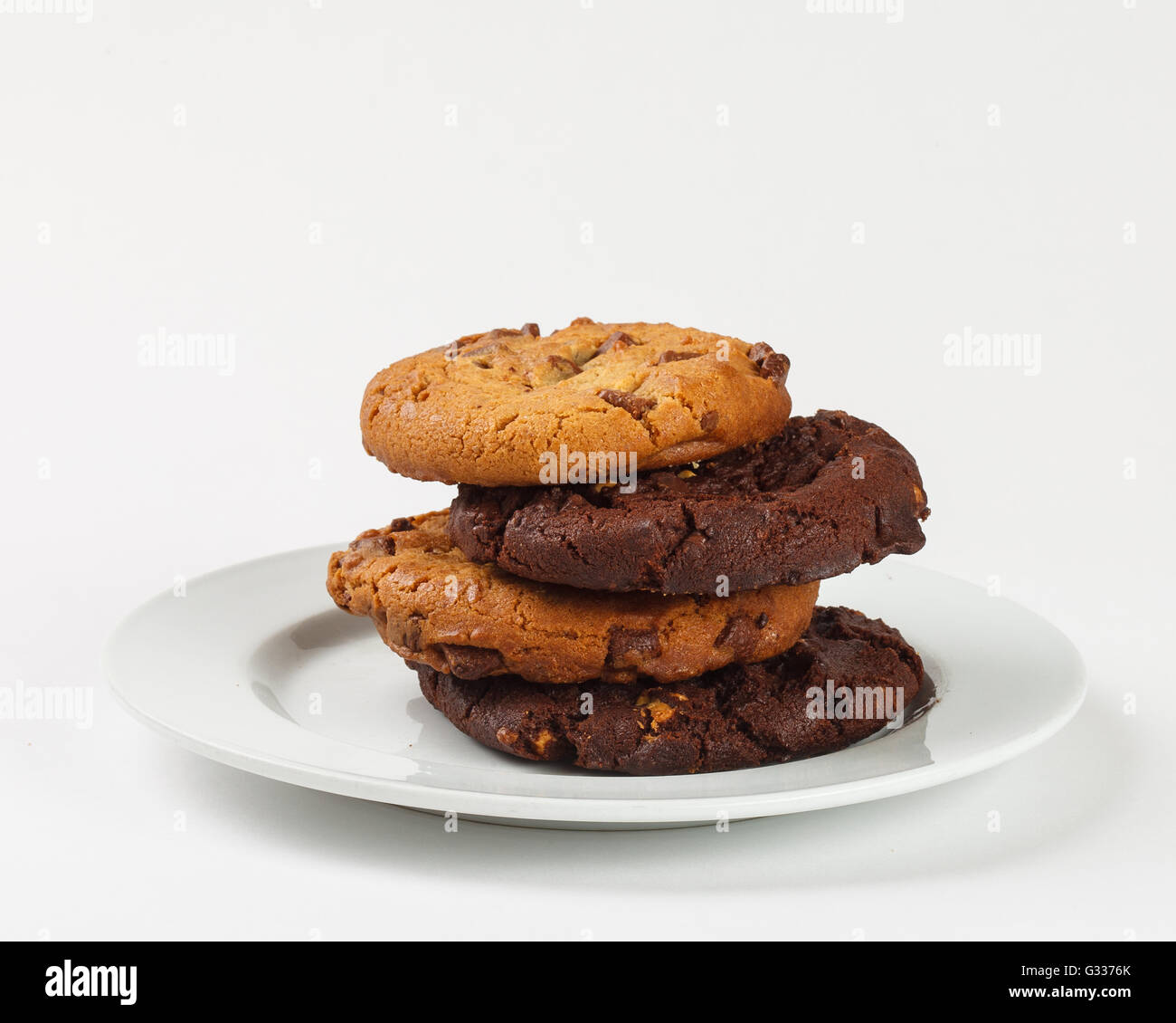 Cookies biscuit with chocolate chips on the plate on white background. Close up side view. Stock Photo