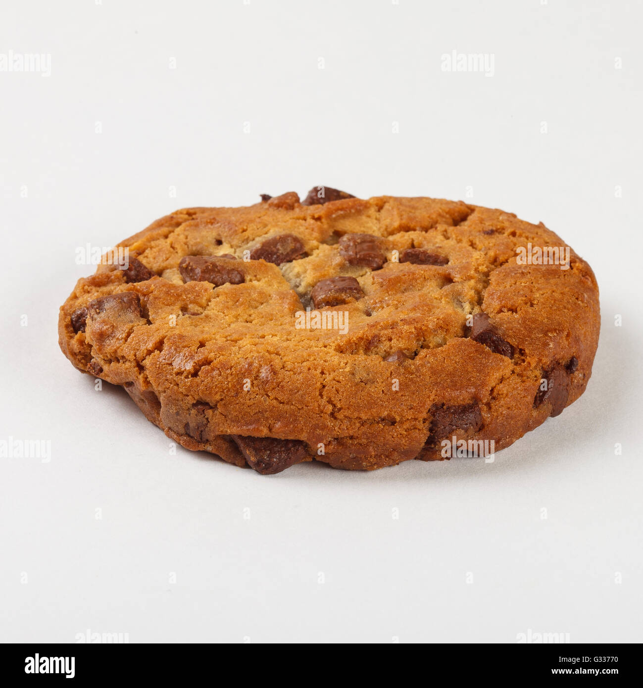 Delicious  biscuit cookie with chocolate chips white background. Close up side view. Stock Photo