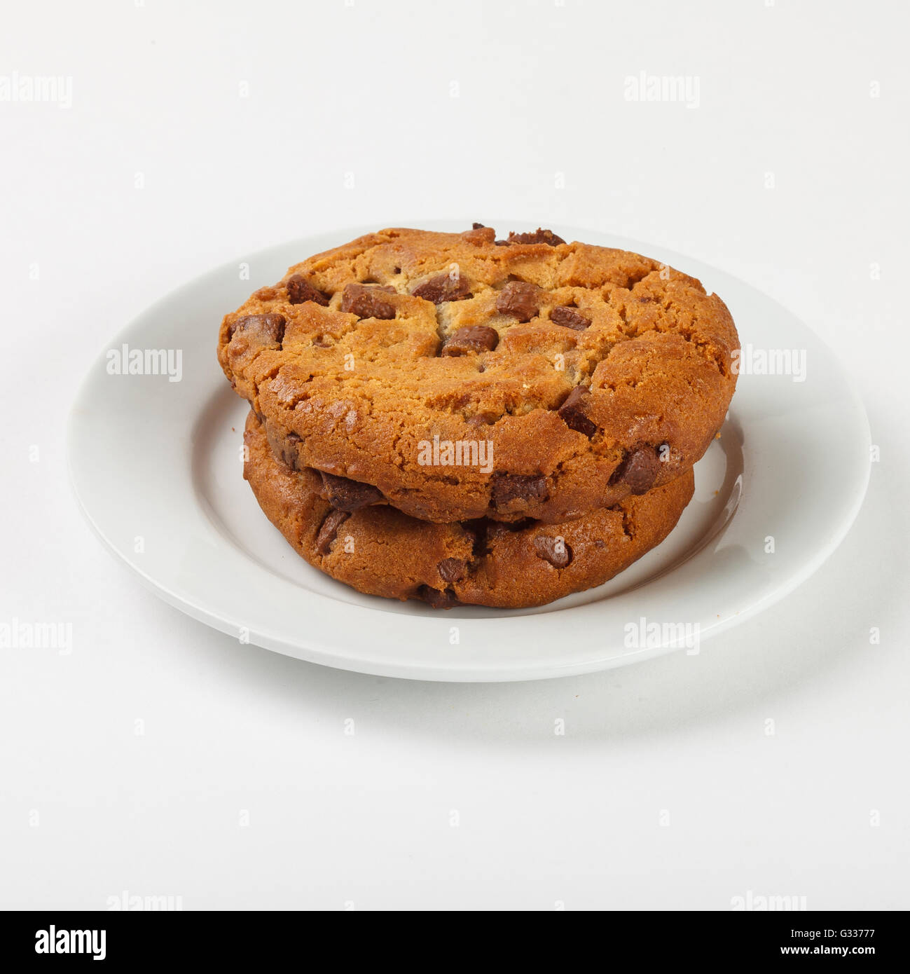 Delicious  biscuit cookies with chocolate chips on the plate on white background.Close up side view. Stock Photo
