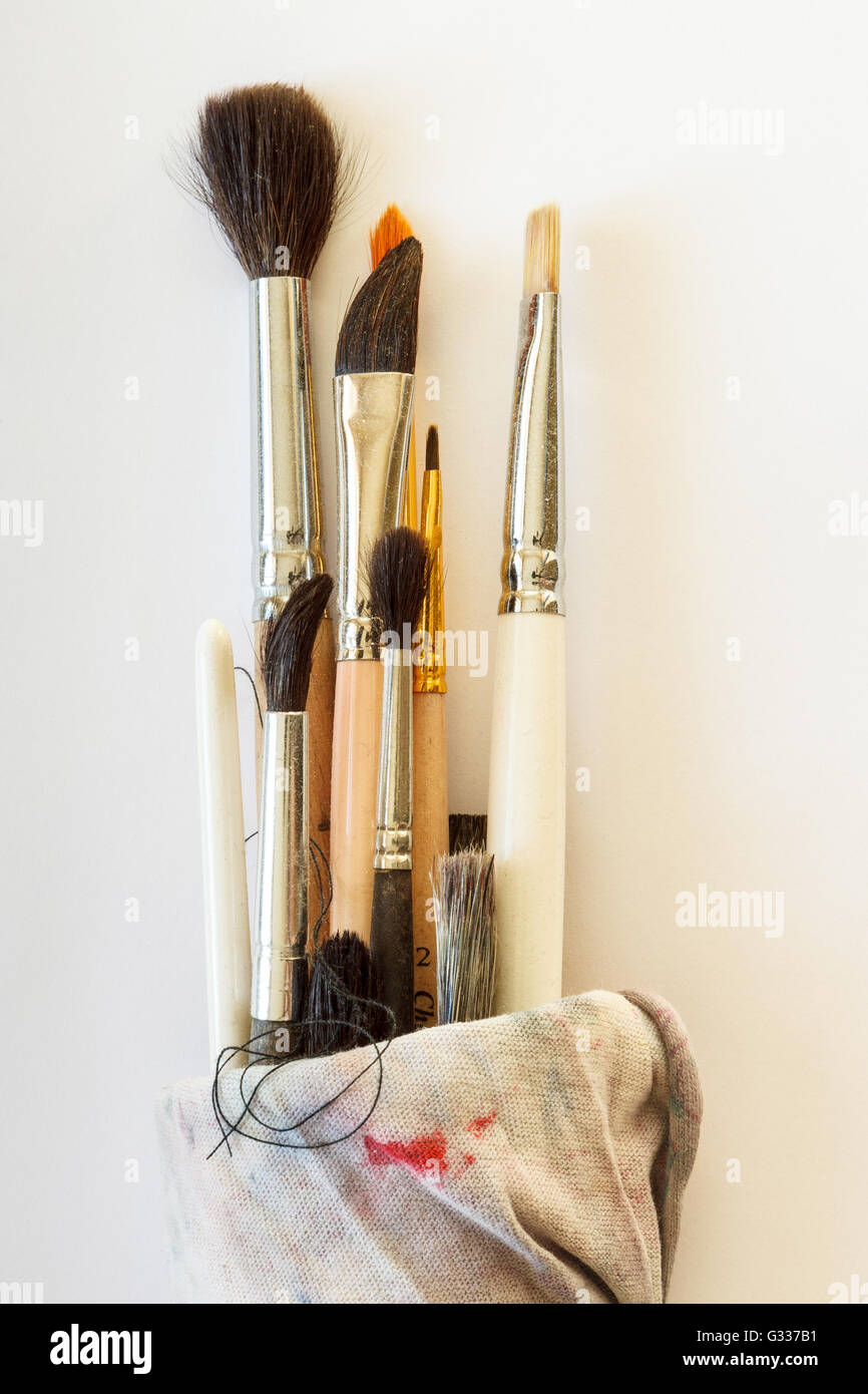 Painting brushes wrapped in a rag on a white background. Close up, top view. Stock Photo