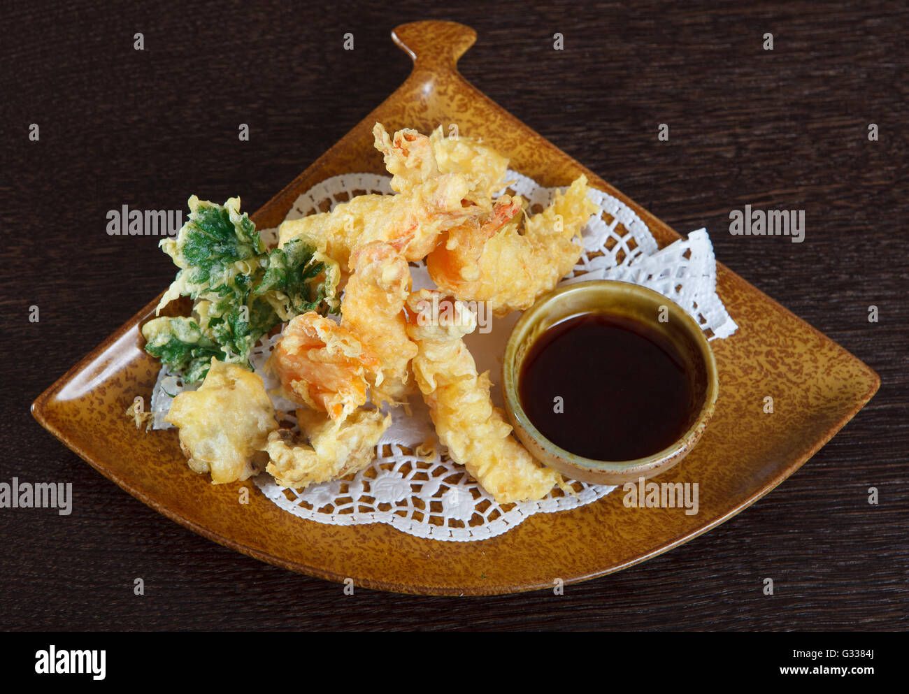 Tempura shrimps (deep fried shrimps) with soy sauce. Decorating dish of Japanese and Asian cuisine. Close up top view. Stock Photo