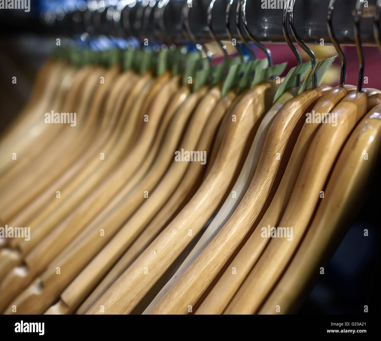 Wooden clothes hangers on a rail. Stock Photo