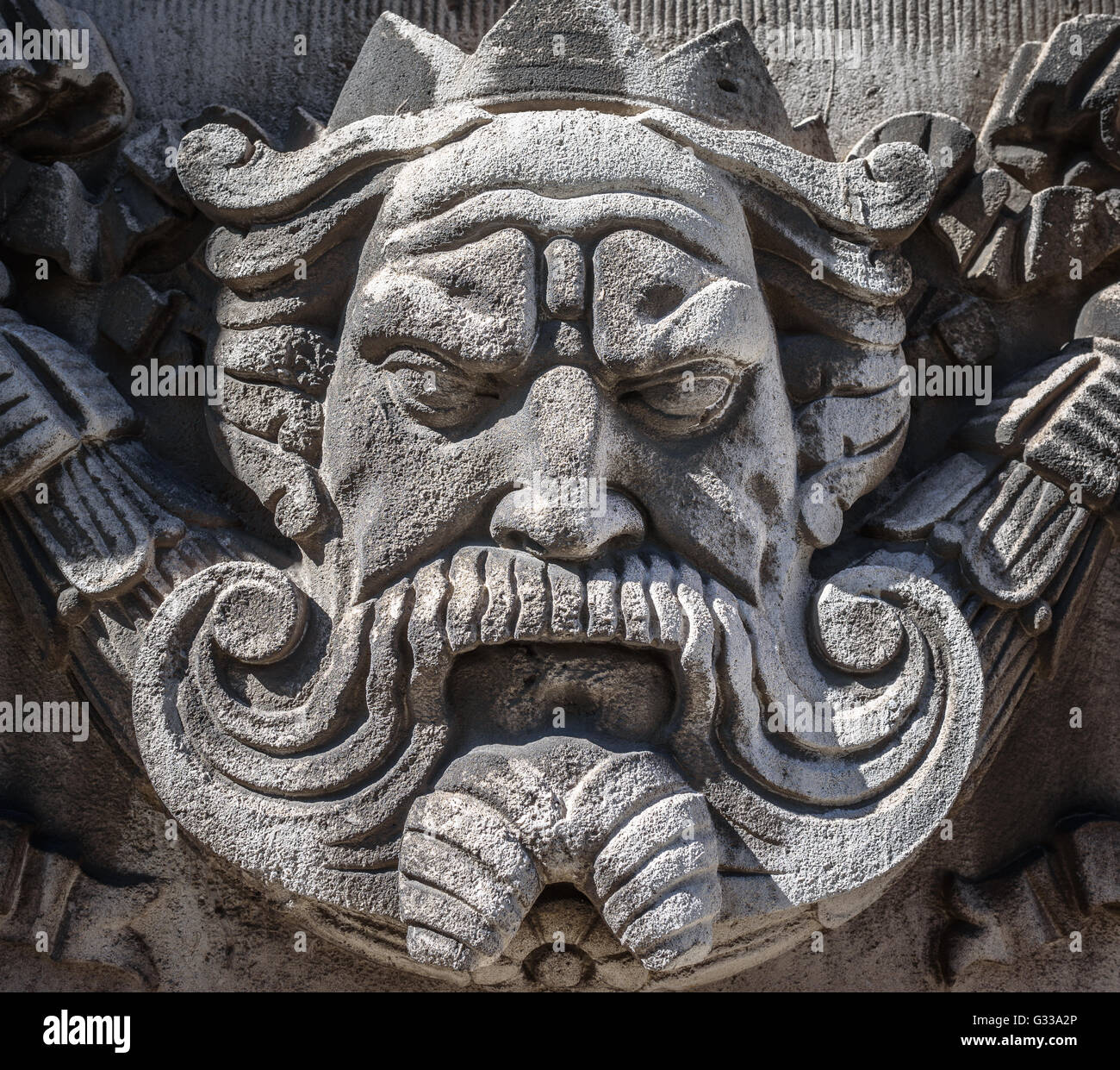 The face of a king carved in stone on the facade of a building in Liverpool. Stock Photo