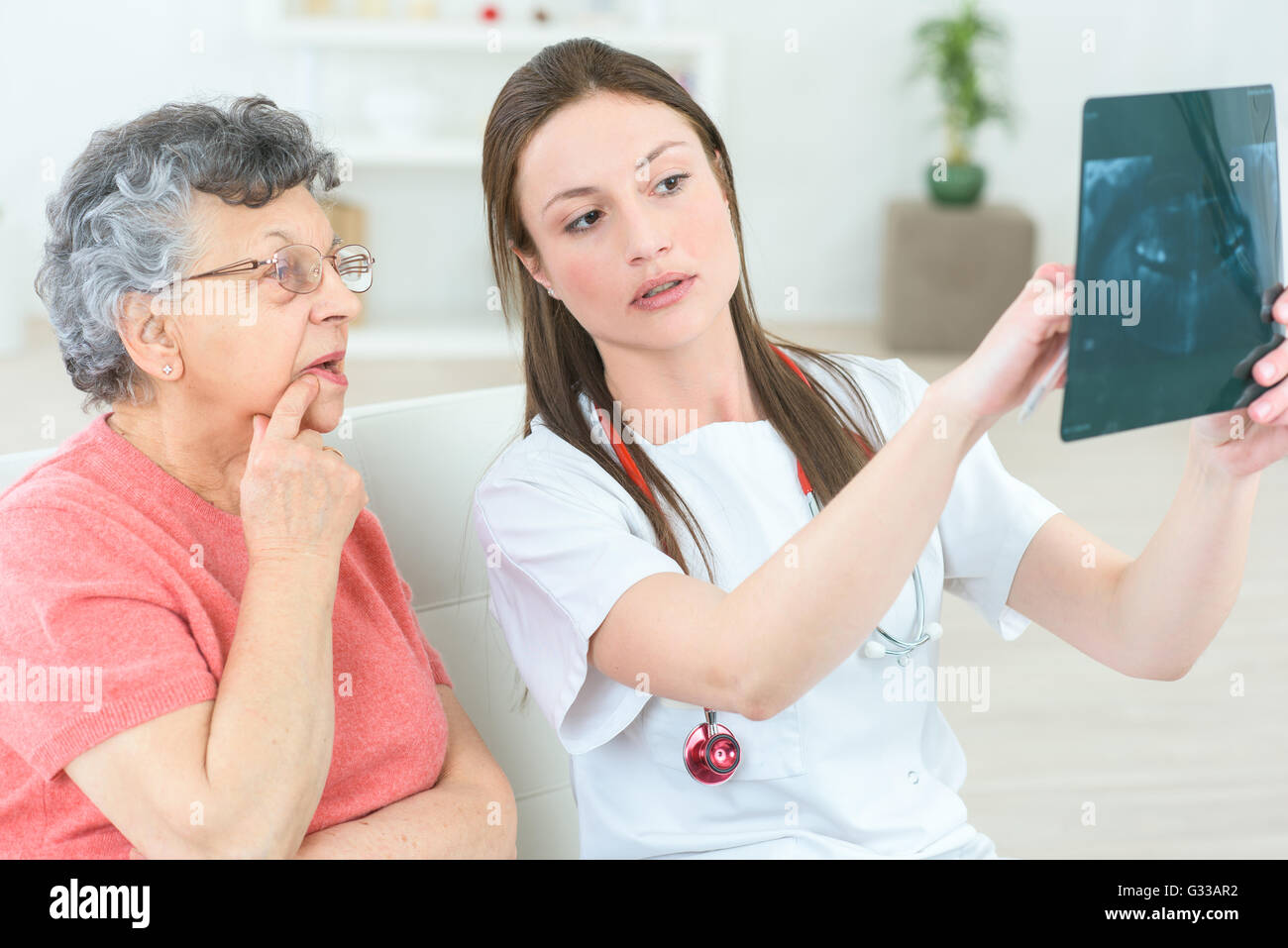 Showing a senior patient her x-ray Stock Photo - Alamy