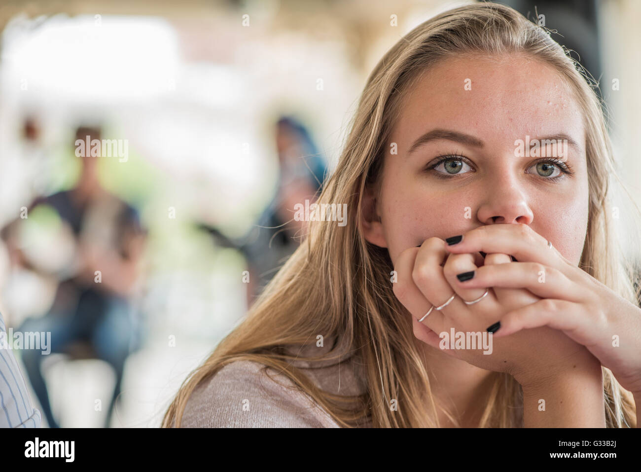 Teenager in deep thought listening to live music Stock Photo