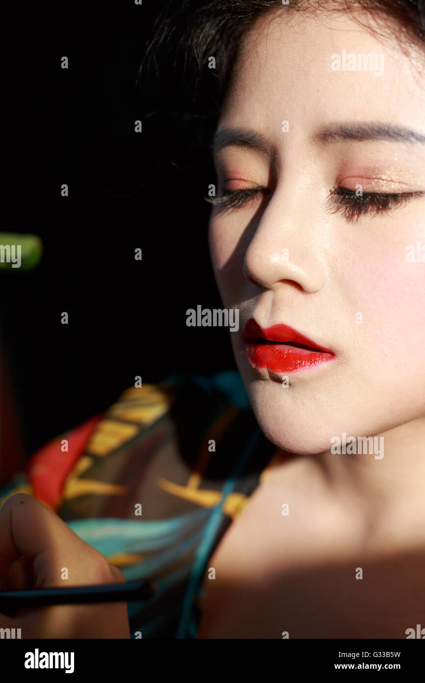 Asian girls are making up face feature Stock Photo - Alamy