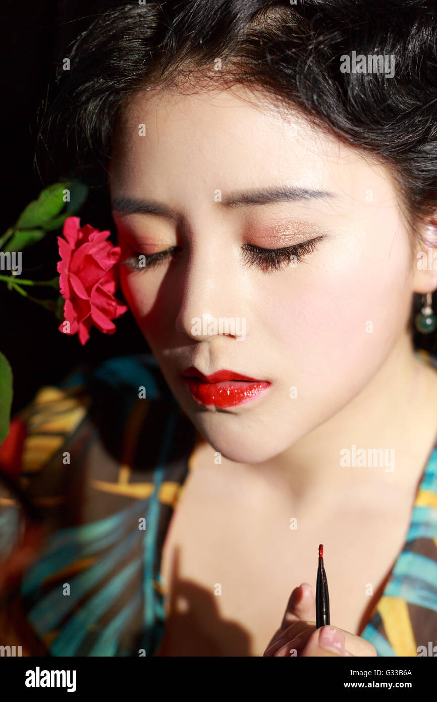 Asian girls are making up face feature Stock Photo - Alamy