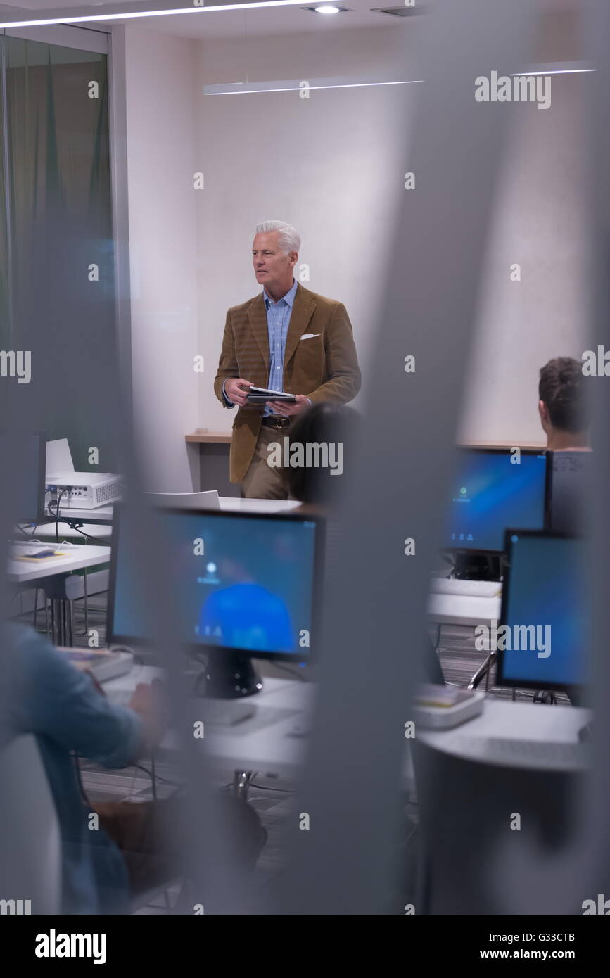 handsome mature teacher and students in computer lab classroom Stock ...