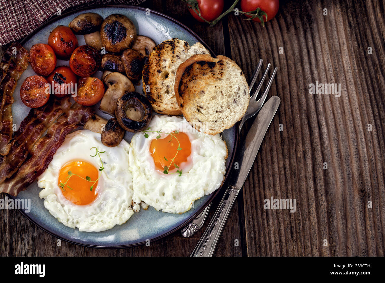 English breakfast with eggs, tomatoes, mushrooms, bacon, beans Stock